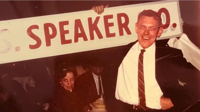 founder cliff digre holding a early misco sign